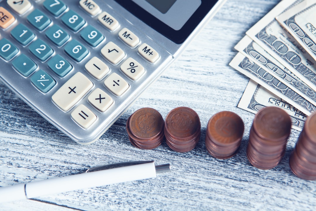 why-choose-us a-calculator-pen-and-money-on-a-table-x4vwfpzy-2o